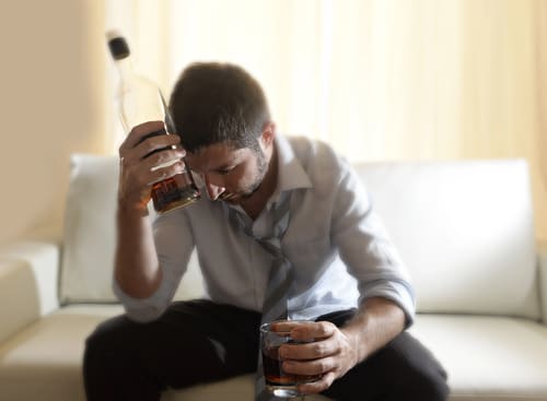 a high functioning alcoholic man drinking after work