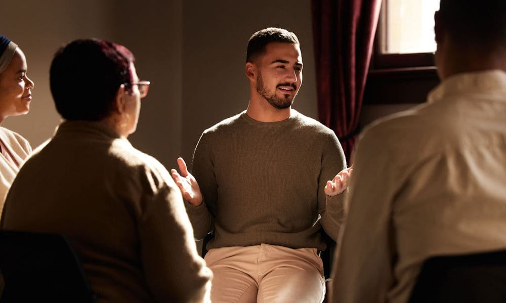 Man explaining alcohol addiction to support group