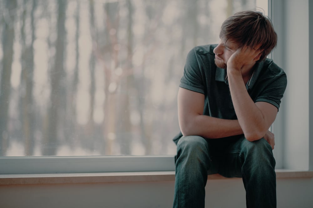 Man sitting alone, reflecting on marijuana addiction