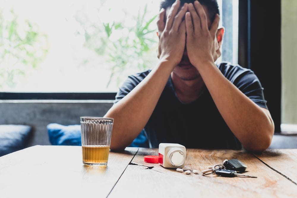 man mixing alcohol with other drugs