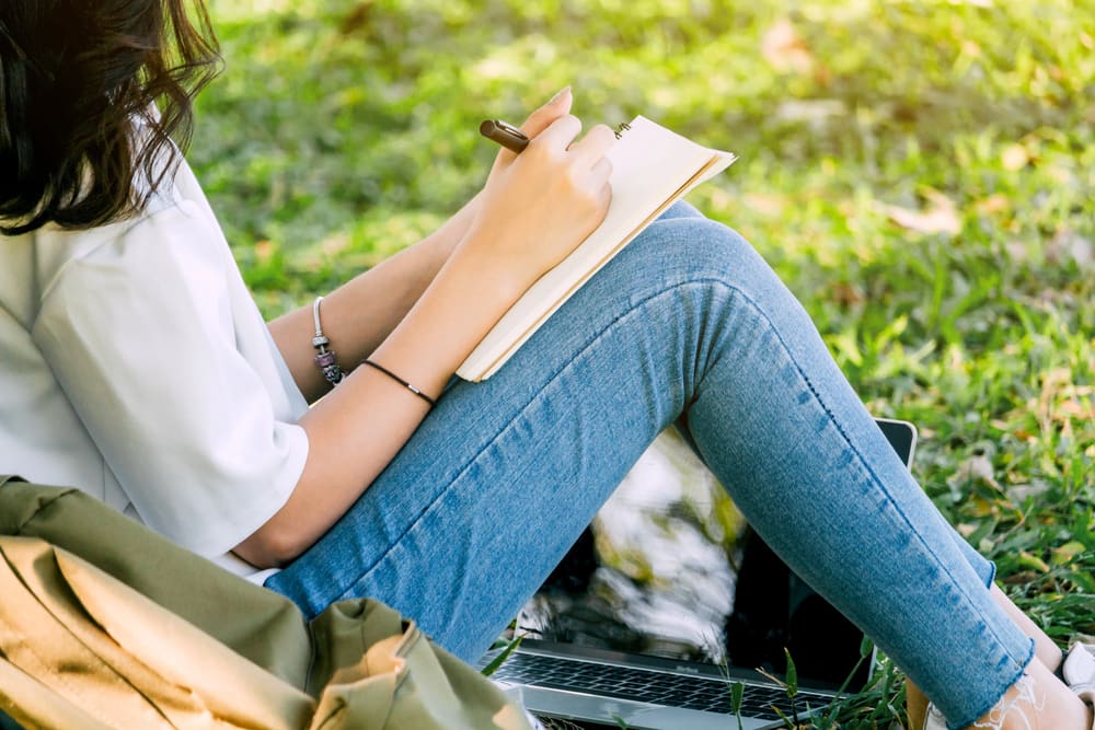 woman writing as part of her addiction and mental health treatment