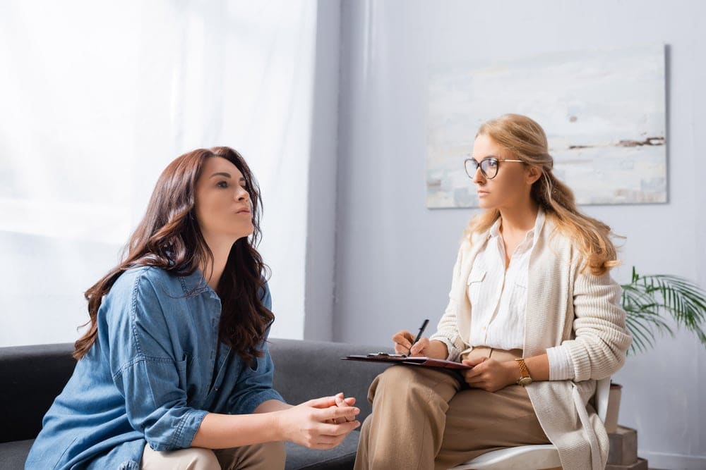 Patient and therapist discussing items to bring for addiction treatment