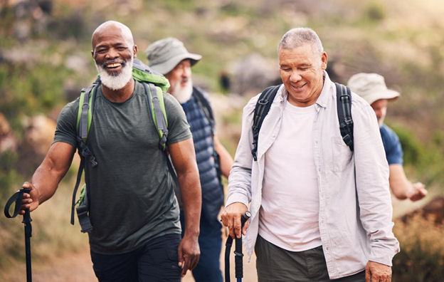 Group of older men walking along a trail as part of a relapse prevention activity in Texas