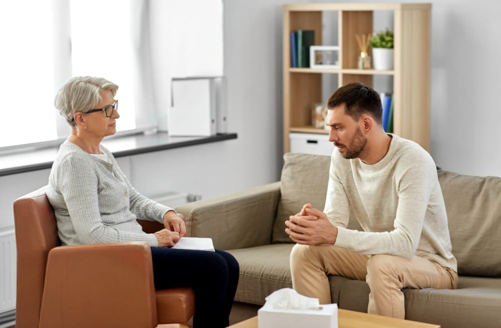 a man during therapy session with phycologist
