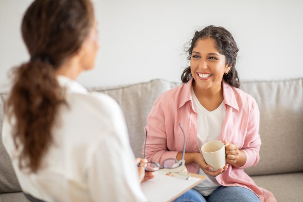 patient of addiction treatment happy that her insurance can cover rehab