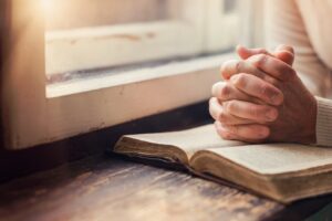 Person seeking spiritual guidance during addiction recovery treatment