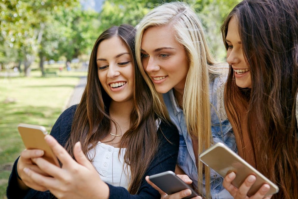 teens using phones to check social media