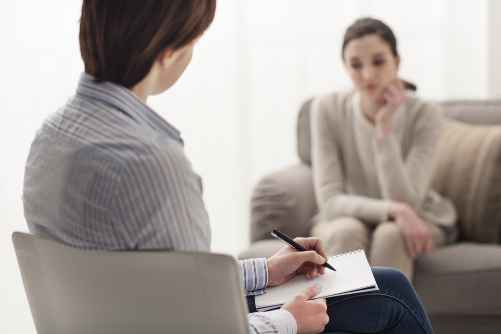 psychologist listening to her patient who is finding her addiction treatment very challenging