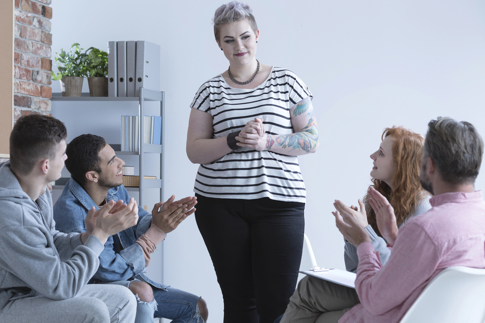 woman in group therapy making the best out of her recovery program