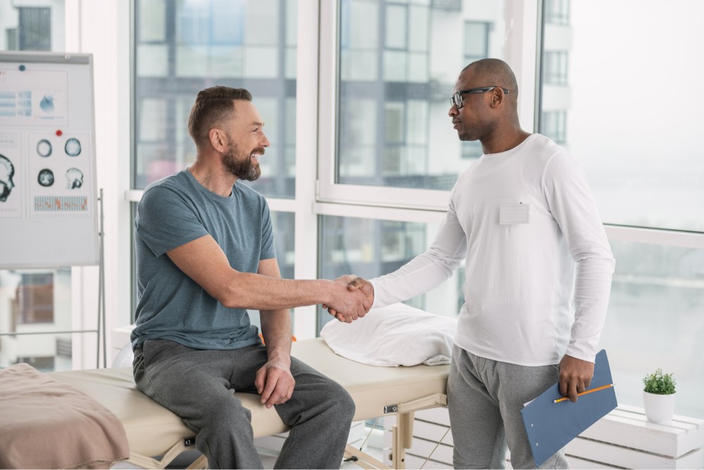men shake hands, one showing interest on self mental wellbeing