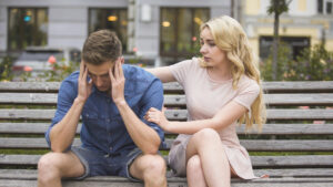 couple sitting on a bench, showing compassion and tolerance 