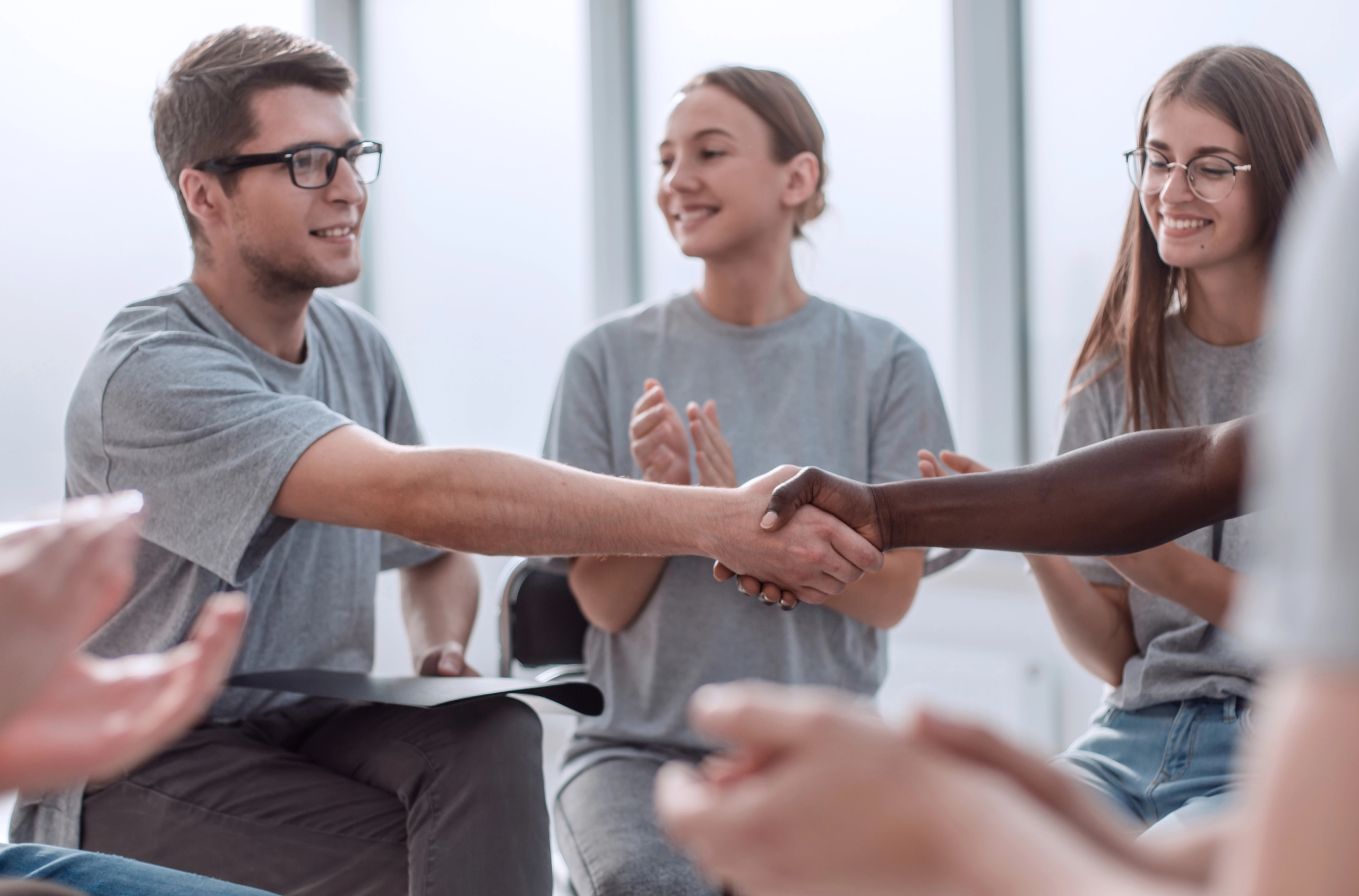 man shakes hand with one of his support group member