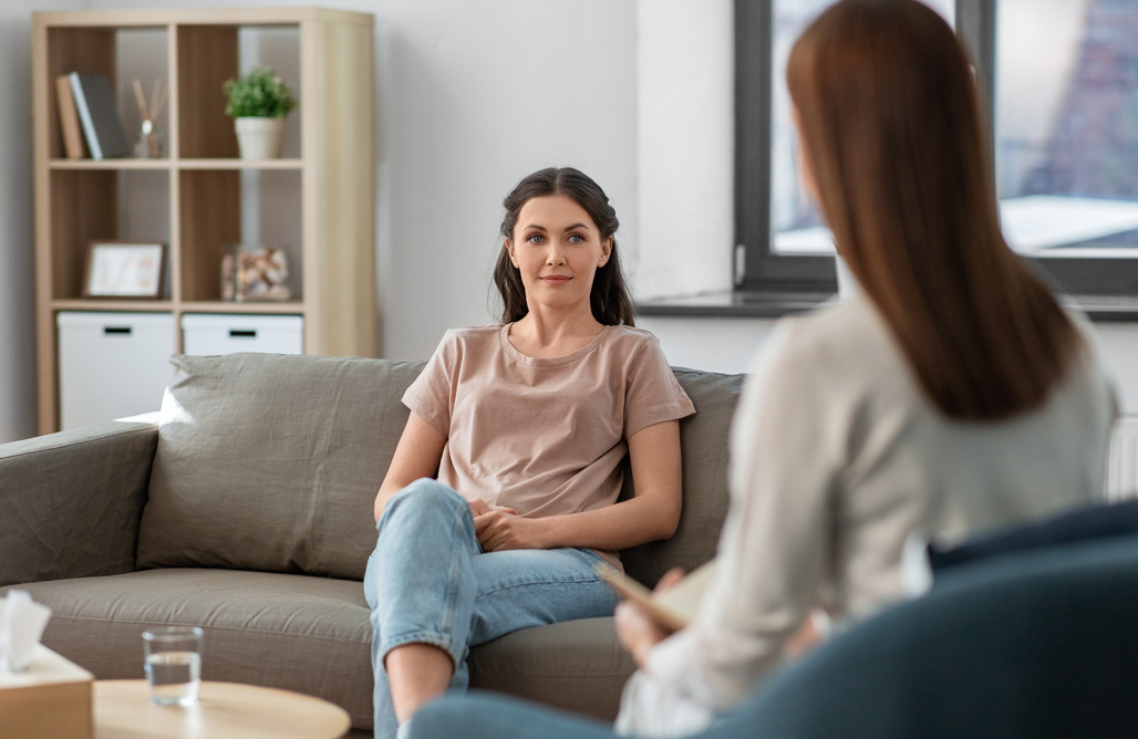 woman and psychologist at psychotherapy session