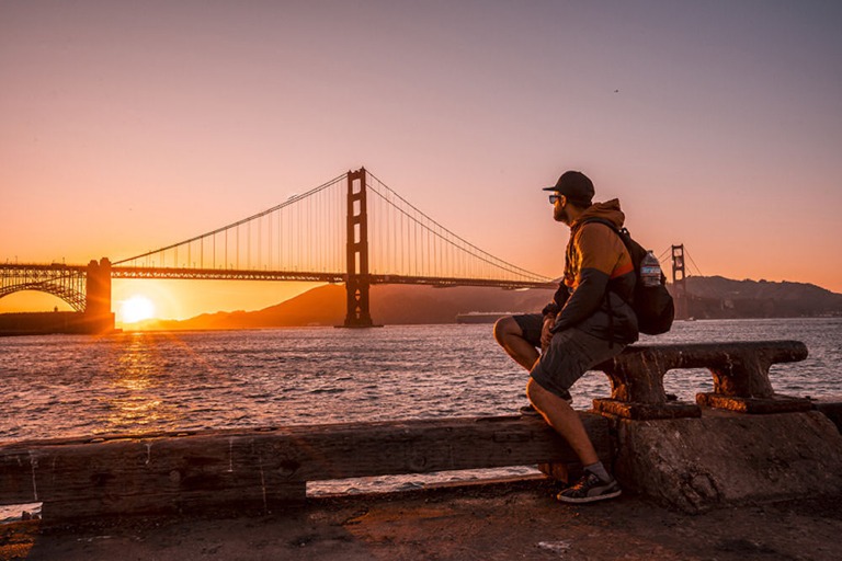 First responder on break looking out at the Golden Gate bridge from hiking trail