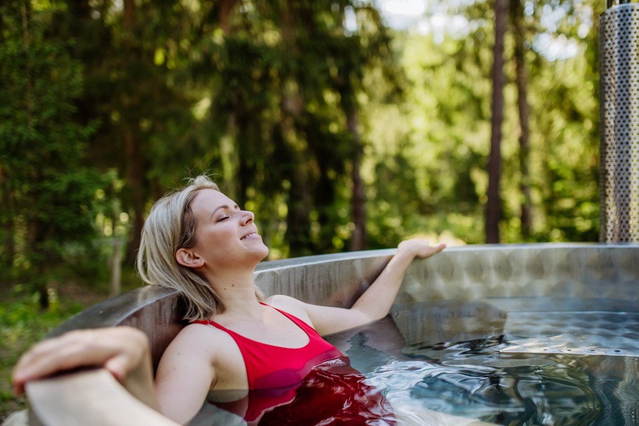 Woman relaxing in hot tub as coping mechanism for addiction cravings