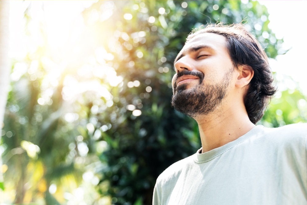 Relaxed man closing eyes while detoxing from alcohol