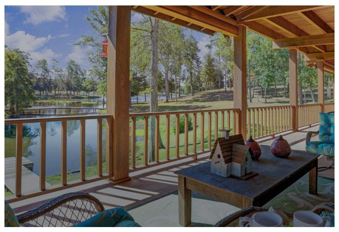 Peaceful porch view overlooking a lake and forest at a Texas drug rehab retreat
